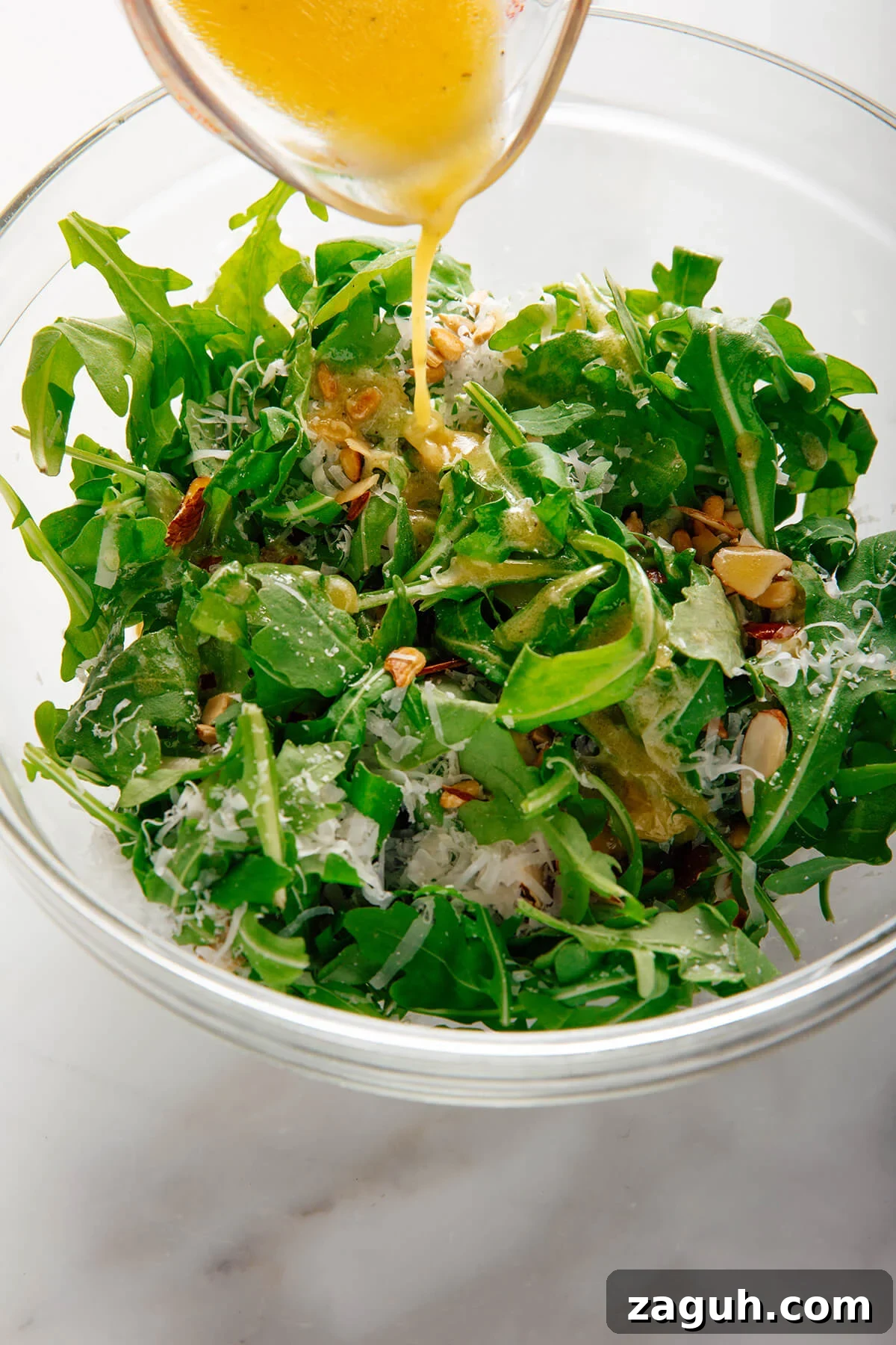 pouring dressing into salad