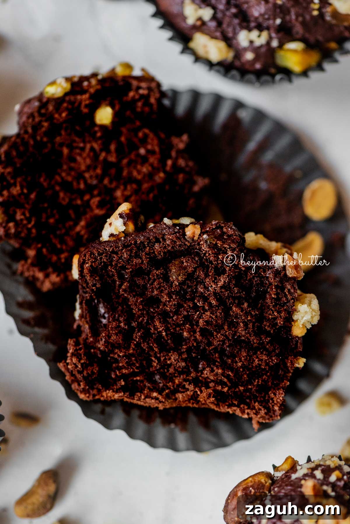 Dark Chocolate Pistachio Cream Cheese Muffins Recipe 5 Dark chocolate pistachio cream cheese muffins with center muffin unwrapped and cut in half | All Images © Beyond the Butter™