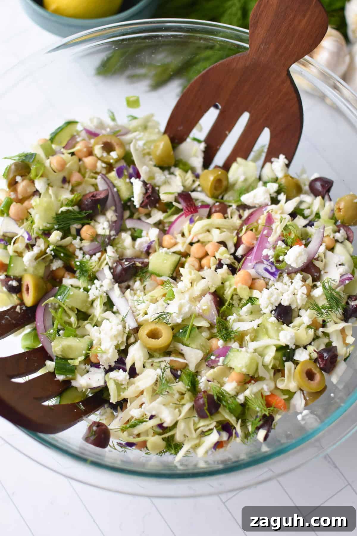 Greek Cabbage Salad Recipe with Feta and Lemon Dressing 2 Greek Cabbage Slaw Salad mixed in a large bowl