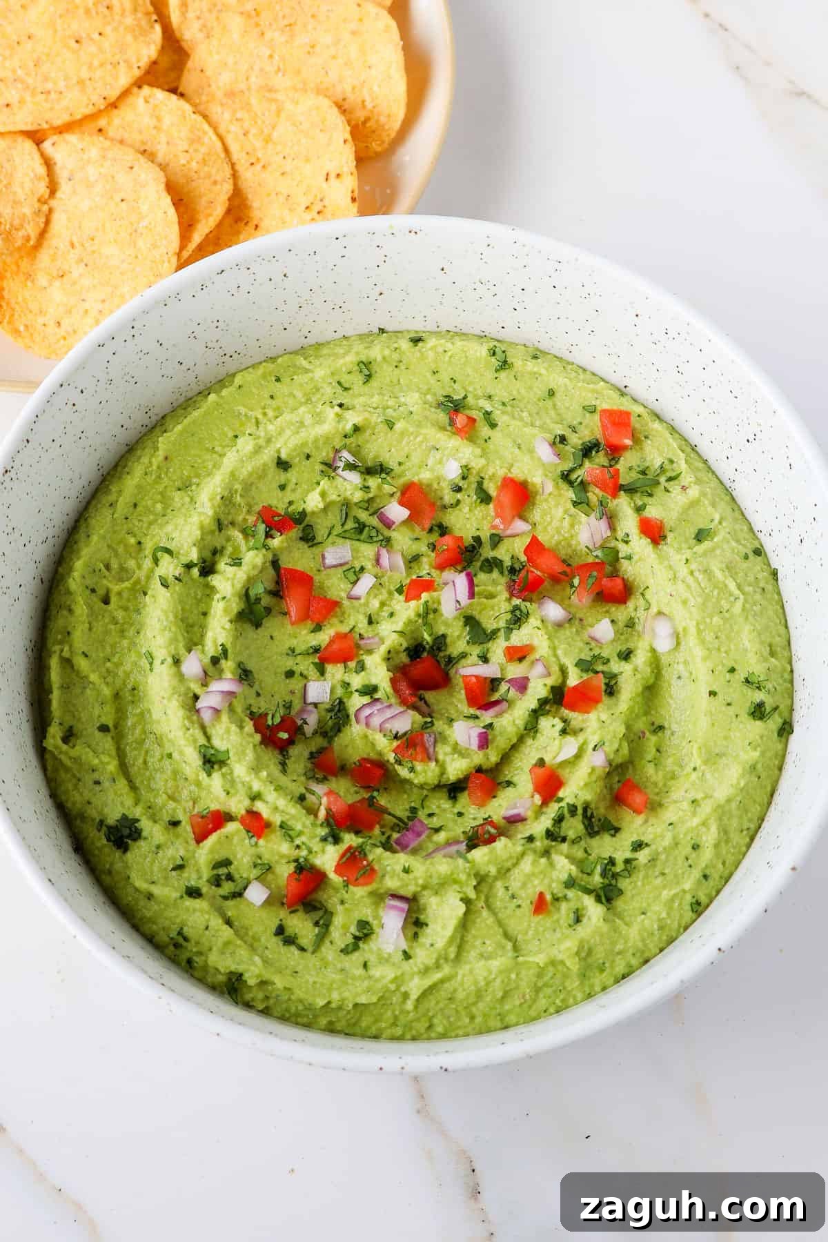 Protein-Packed Edamame Guacamole Recipe for Muscle Fuel 3 Side shot of guacamole in a bowl.