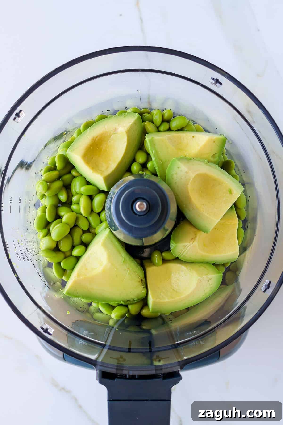 Protein-Packed Edamame Guacamole Recipe for Muscle Fuel 5 Edamame and avocado chunks in a food processor.