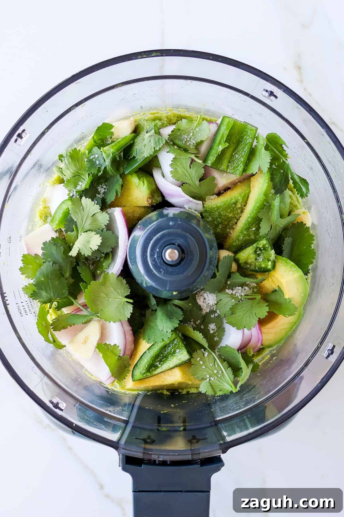 Protein-Packed Edamame Guacamole Recipe for Muscle Fuel 7 Avocado chunks, coriander, red onion, garlic, jalapeño in a food processor.