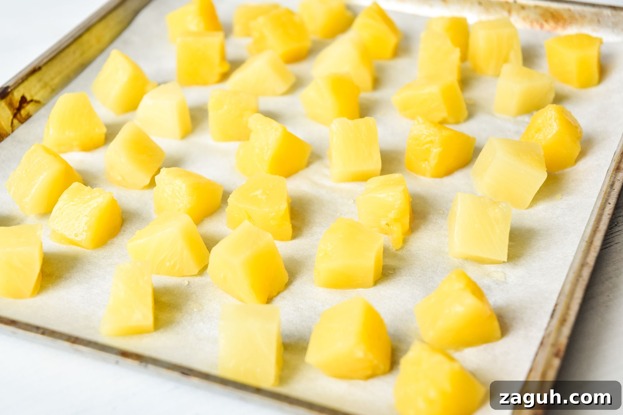 Refreshing Summer White Wine Sangria Recipe for Warm Evenings 4 sheet pan of pineapple chunks to be frozen for summer white wine sangria
