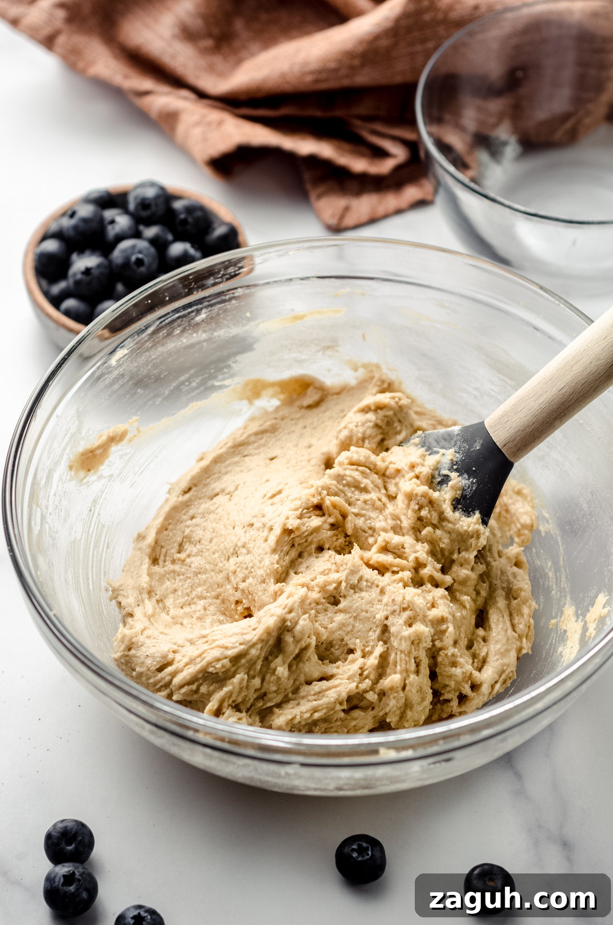 Moist Blueberry Sour Cream Coffee Cake Recipe 11 Batter for coffee cake in a glass bowl with a spatula.