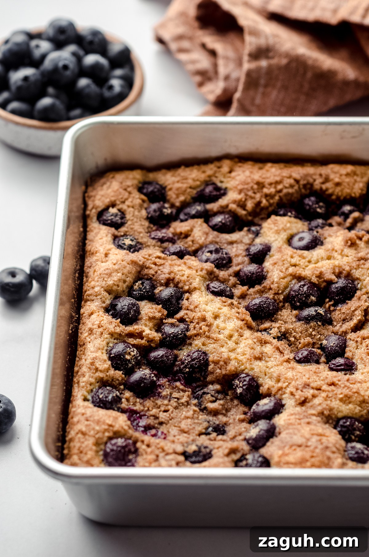 Moist Blueberry Sour Cream Coffee Cake Recipe 17 Blueberry sour cream coffee cake in a baking pan.