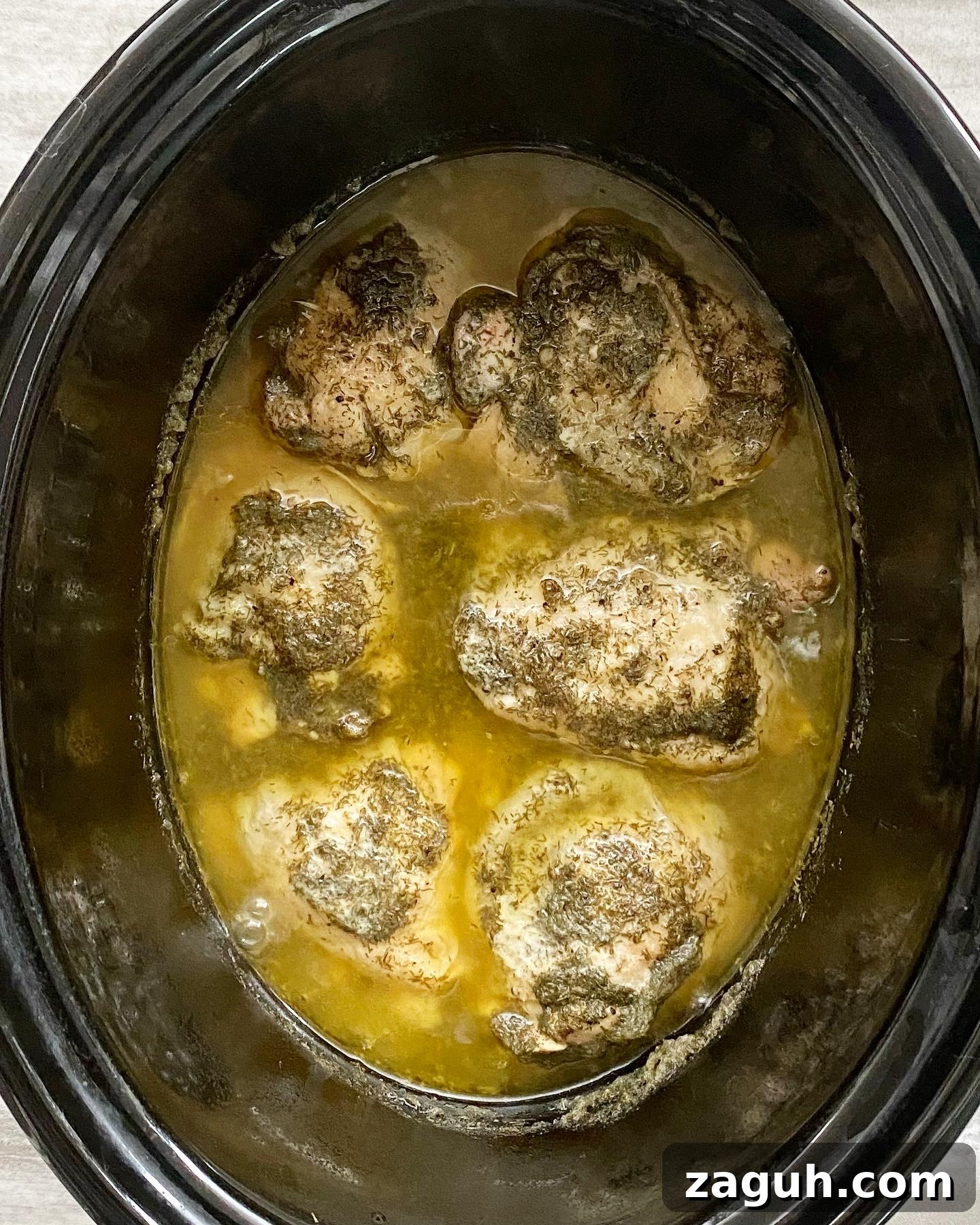 Creamy Lemon Dill Chicken for Slow Cooker: Tender, Flavorful Meal 5 overhead shot of cooked creamy lemon dill chicken in a black slow cooker