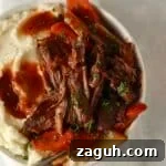 tender pot roast in a bowl with mashed potatoes