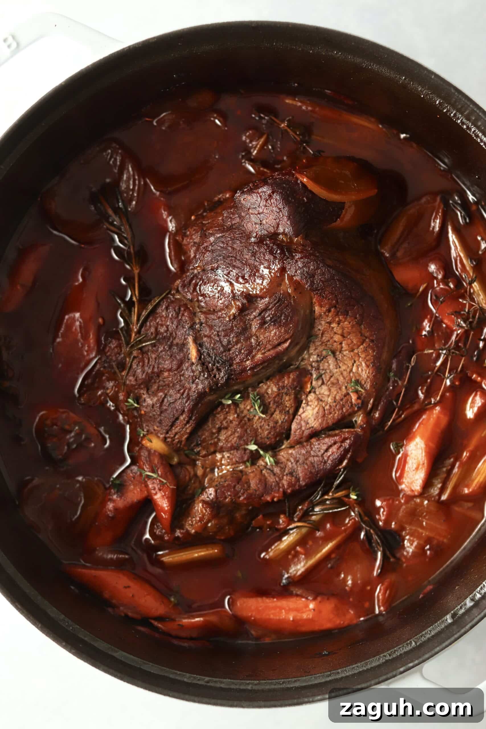 Oven-Braised Chuck Roast Recipe for Moist, Flavorful Beef 3 tender chuck roast in oven with veggies