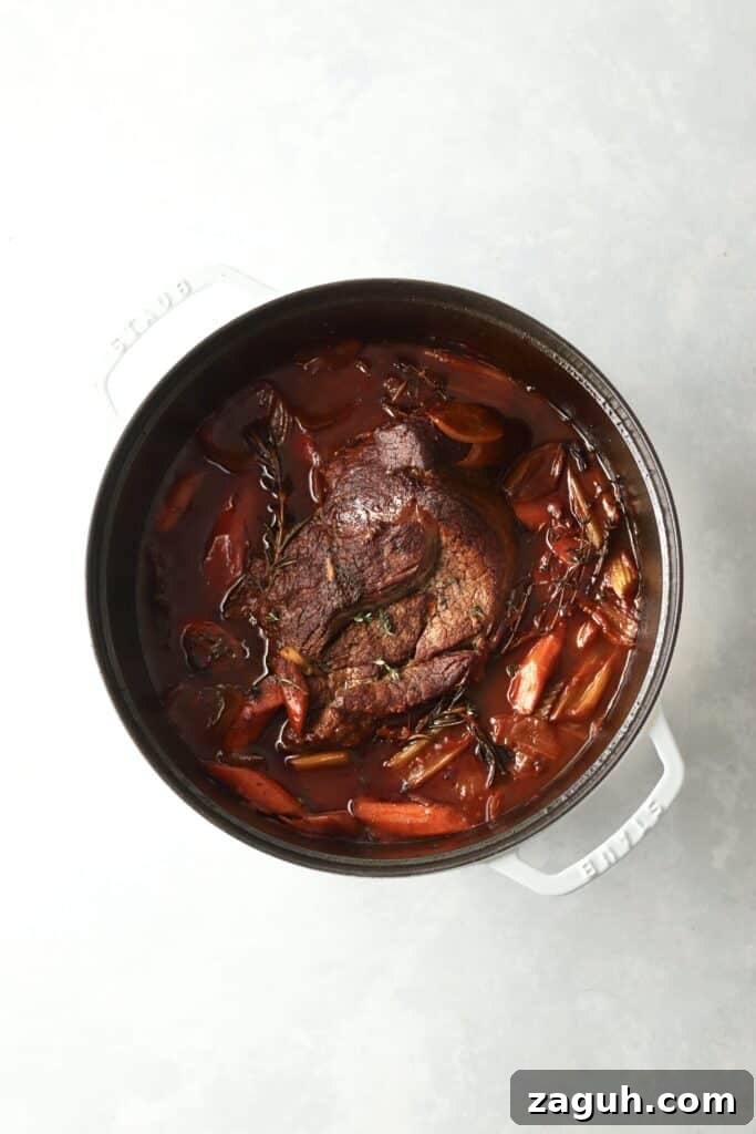 Oven-Braised Chuck Roast Recipe for Moist, Flavorful Beef 7 chuck roast in dutch oven with veggies