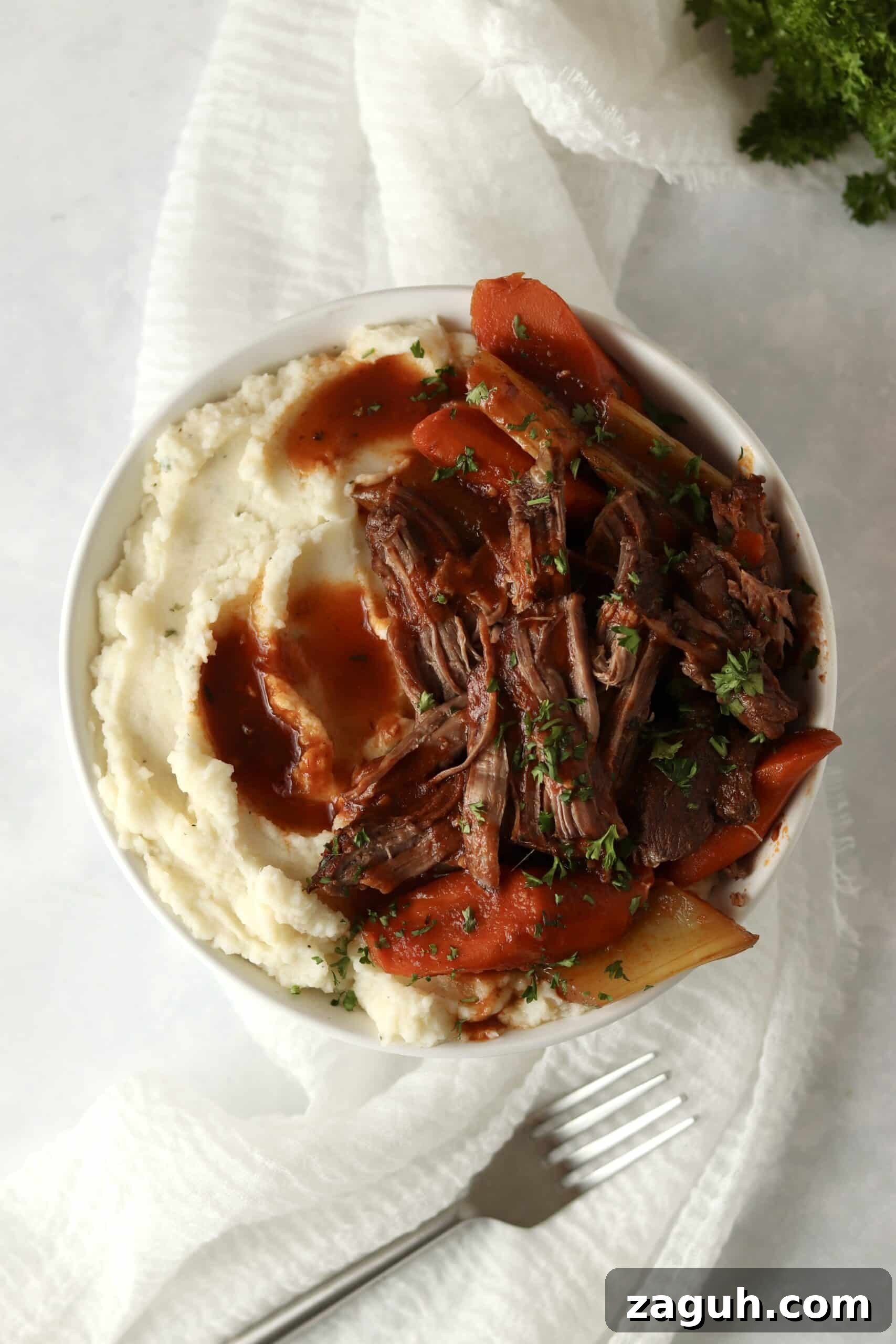 Oven-Braised Chuck Roast Recipe for Moist, Flavorful Beef 10 bowl of chuck roast in oven with mashed potatoes
