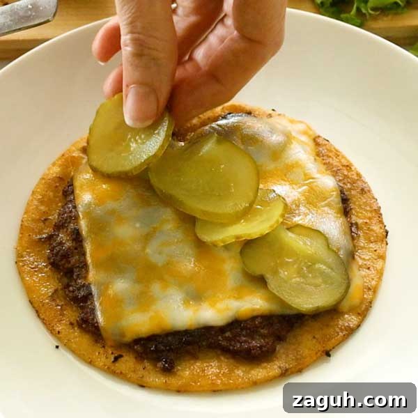 Gluten-Free Big Mac Smashed Tacos Recipe That Went Viral 12 Placing a row of sliced pickles on top of the melted cheese.