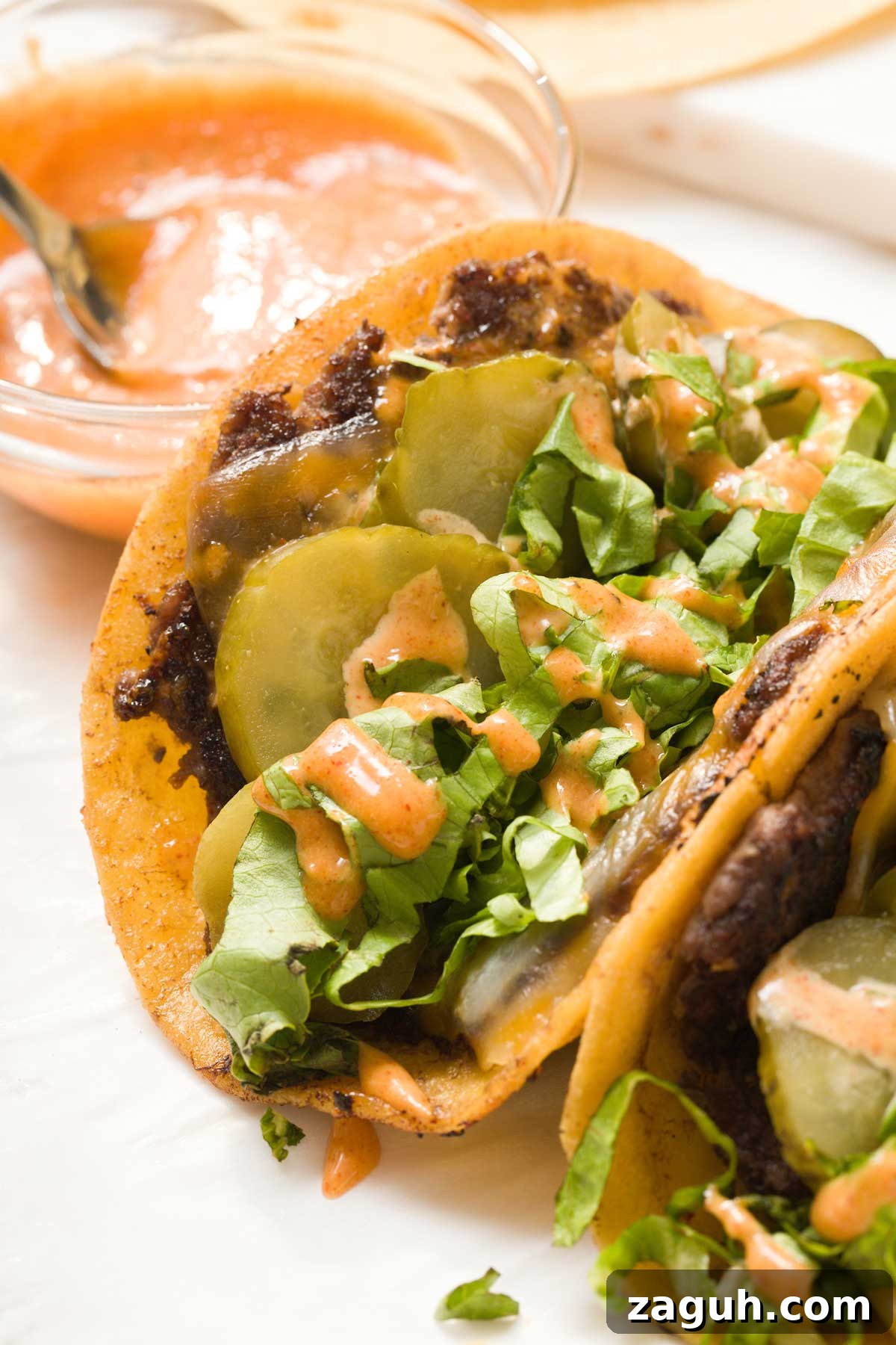 Gluten-Free Big Mac Smashed Tacos Recipe That Went Viral 14 Close-up of a Big Mac taco with pickles, lettuce and sauce.