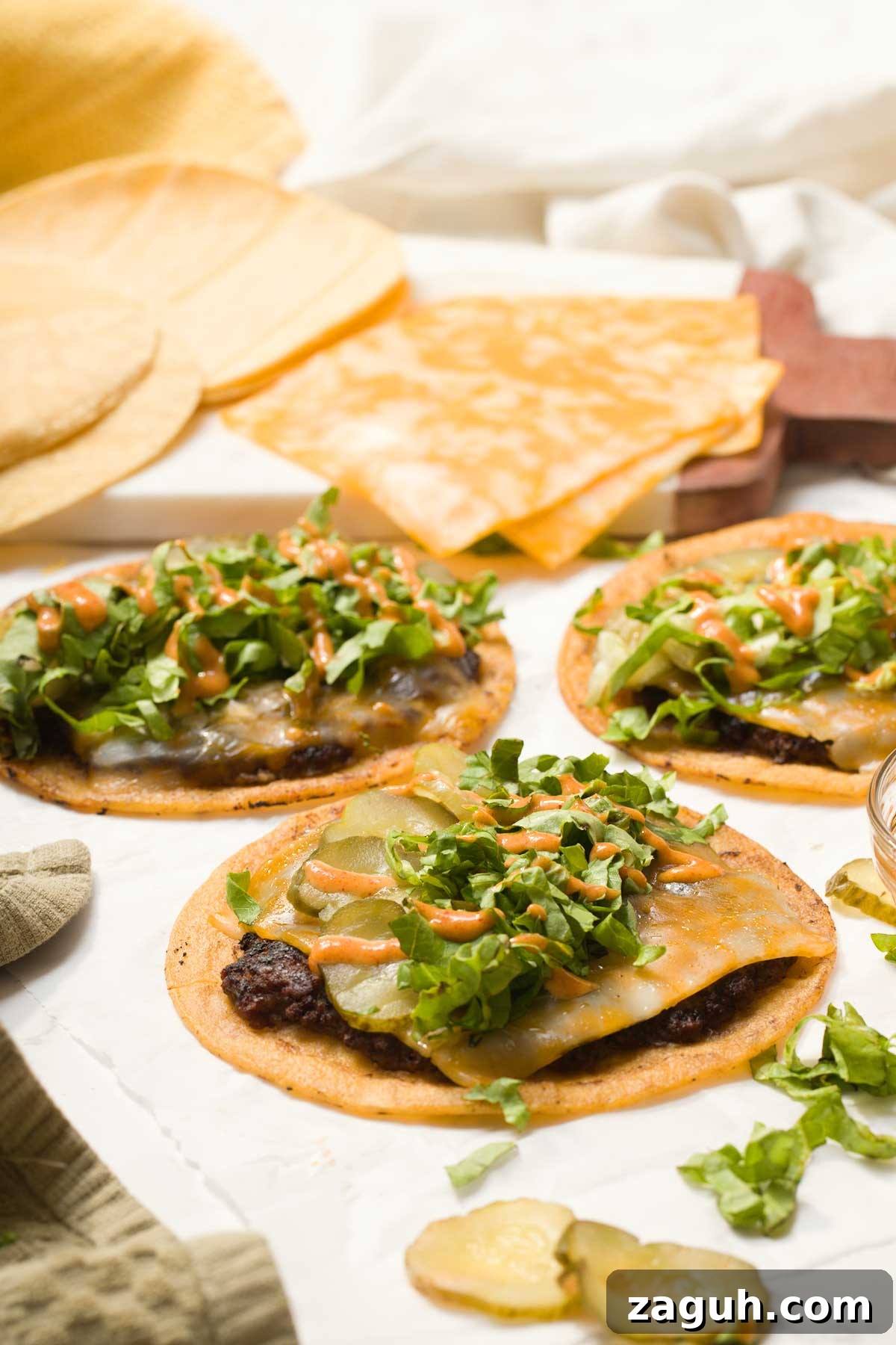 Gluten-Free Big Mac Smashed Tacos Recipe That Went Viral 3 Three big Mac tacos with cheese lettuce and big Mac sauce on top.
