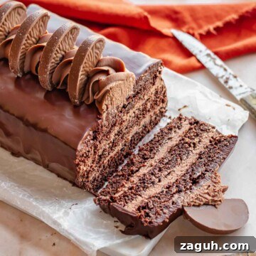 Chocolate orange cake with a slice removed on a platter.