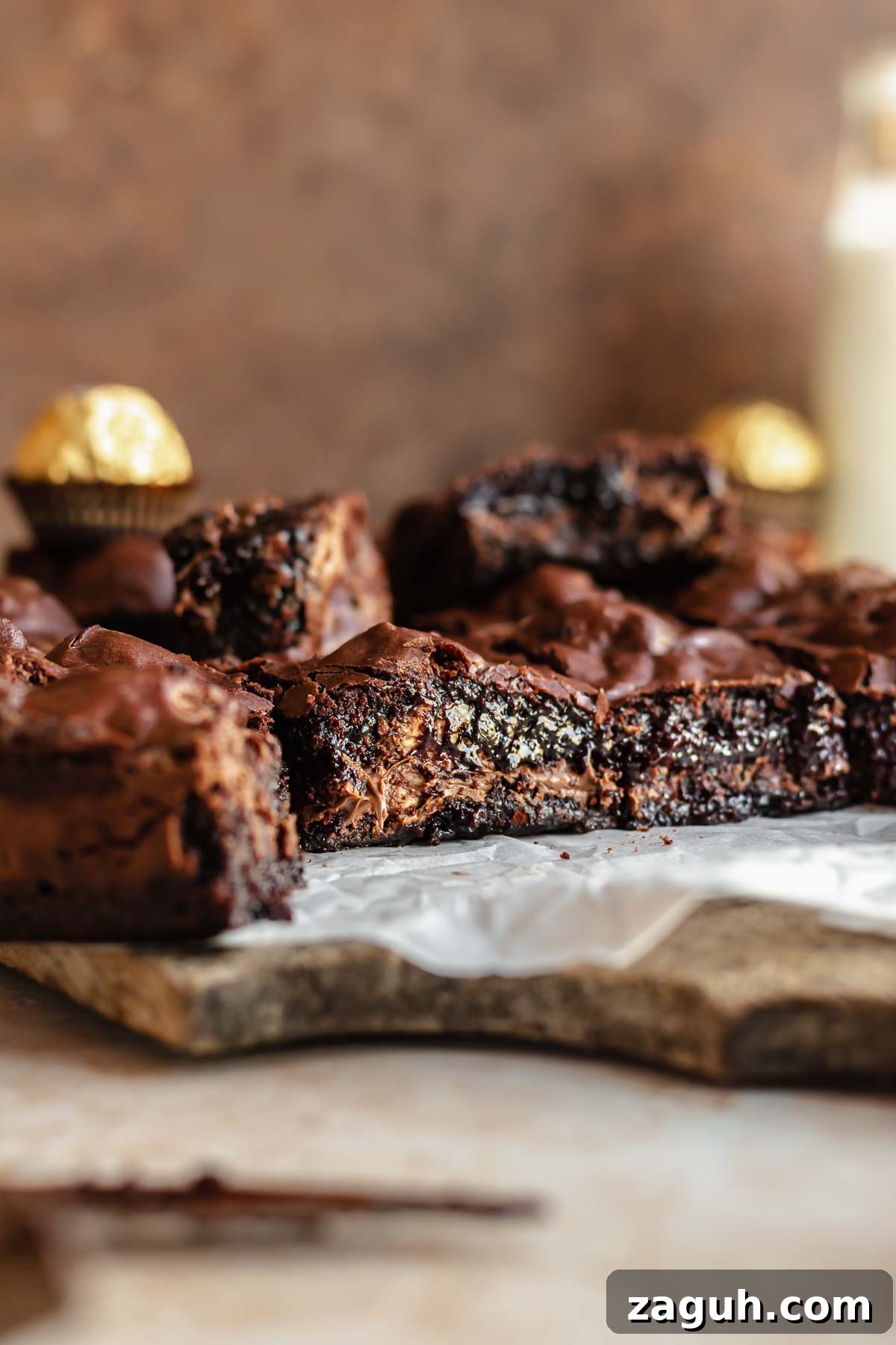 Ferrero Rocher Chocolate Brownies Recipe: Decadent Hazelnut Treat 3 Cut brownies on a cutting board.