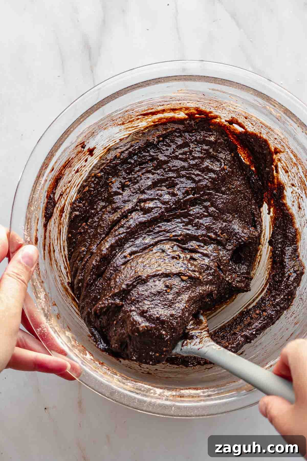 Ferrero Rocher Chocolate Brownies Recipe: Decadent Hazelnut Treat 10 A spatula folds together brownie batter.