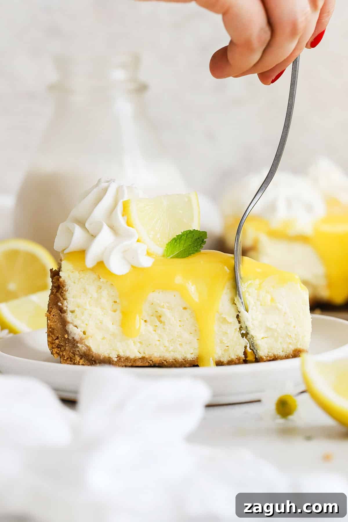 Gluten-Free Lemon Cheesecake Recipe — Zesty No-Bake Dessert 8 a fork getting a bite from a slice of gluten-free lemon cheesecake
