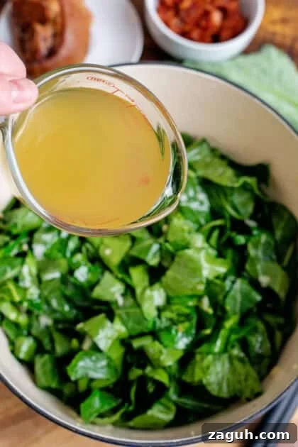 Authentic Southern Collard Greens Recipe That Melts in Your Mouth 12 Adding chicken broth to collard greens in a Dutch oven.