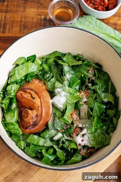Authentic Southern Collard Greens Recipe That Melts in Your Mouth 13 Fresh collard greens in a Dutch oven with a ham hock and baking soda.