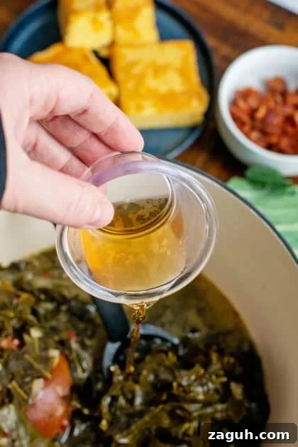 Authentic Southern Collard Greens Recipe That Melts in Your Mouth 15 Pouring apple cider vinegar into a Dutch oven of collard greens.