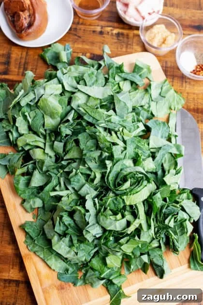Authentic Southern Collard Greens Recipe That Melts in Your Mouth 7 Freshly chopped collard greens on a cutting board.