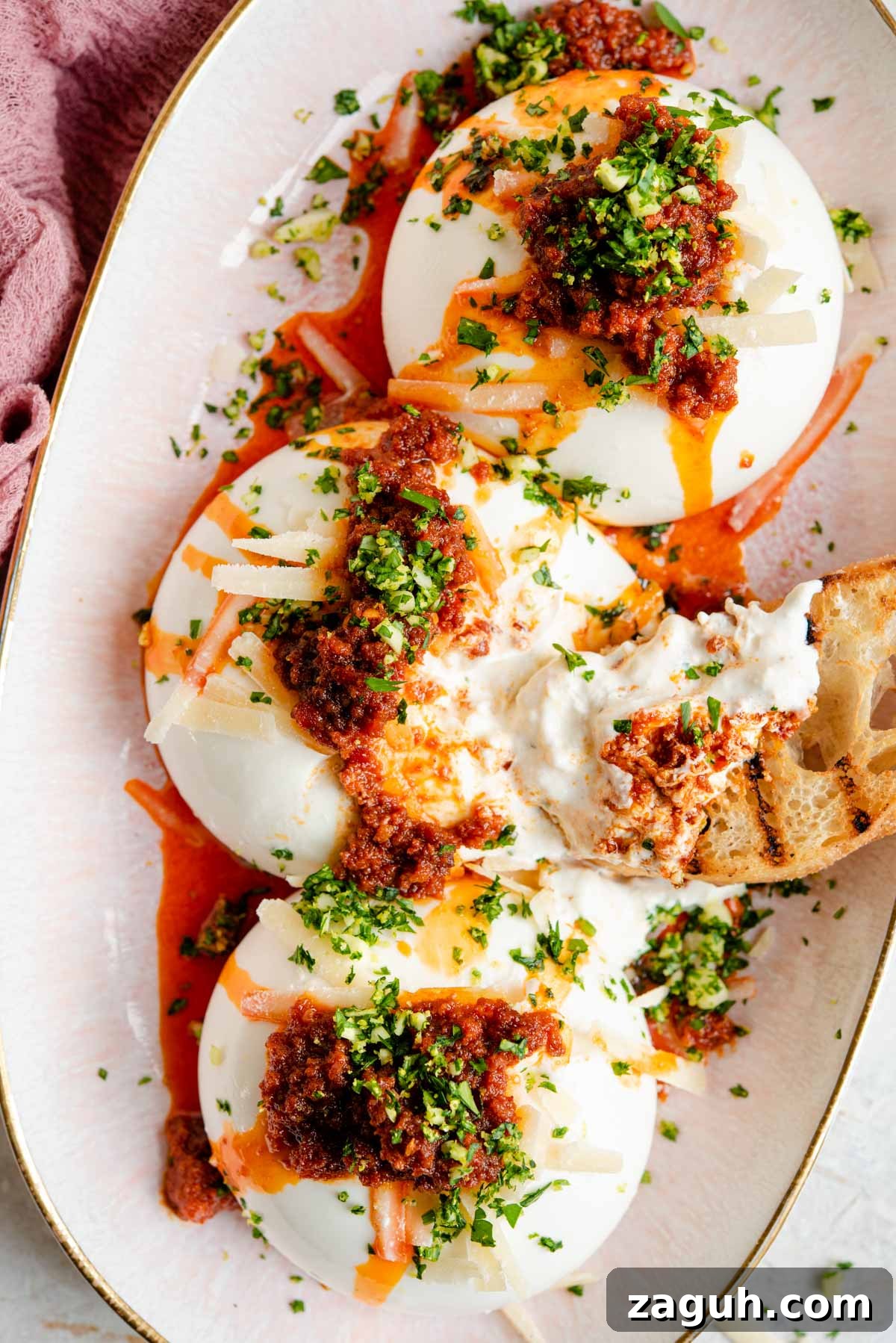 Burrata with Crispy ’Nduja and Bright Gremolata 2 An overhead shot of burrata on a serving plate with 'Nduja and gremolata