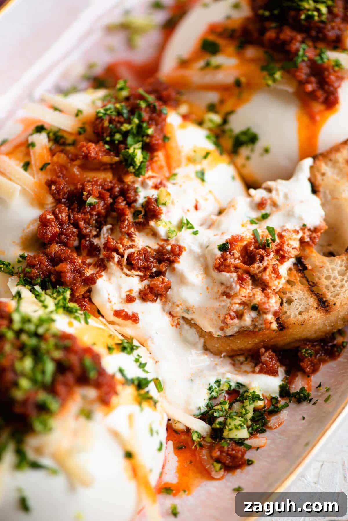 Burrata with Crispy ’Nduja and Bright Gremolata 6 A close up of burrata cheese with 'Nduja and ciabatta bread