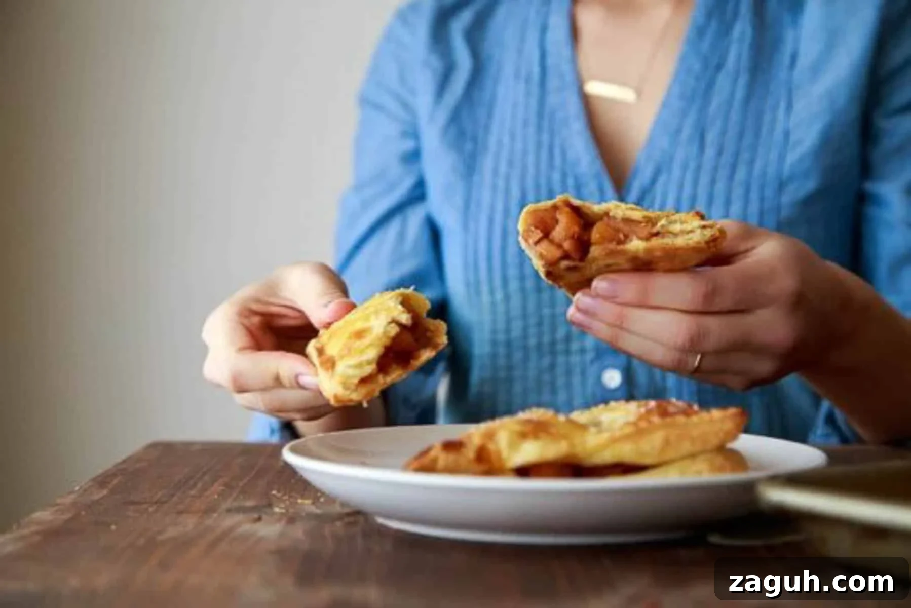 Perfect Puff Pastry Dough: Step-by-Step Homemade Recipe 8 Woman in denim holding apple turnovers split open.
