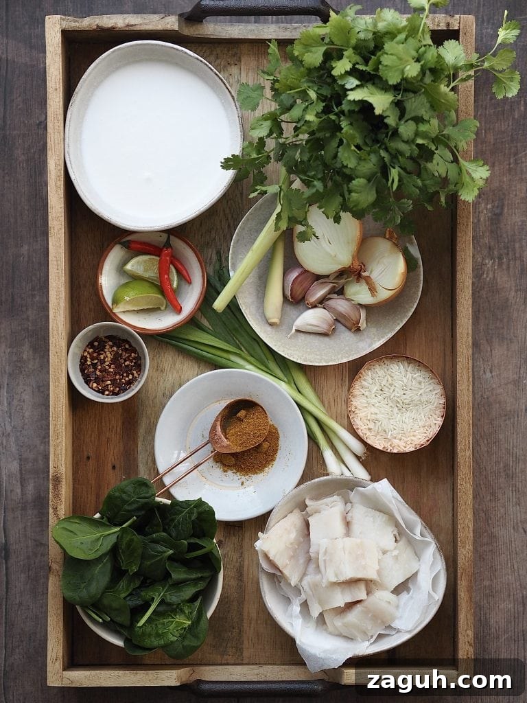 Quick Coconut Fish Curry with Lemongrass and Lime 4 Ingredients to make a fish curry on a wooden tray.