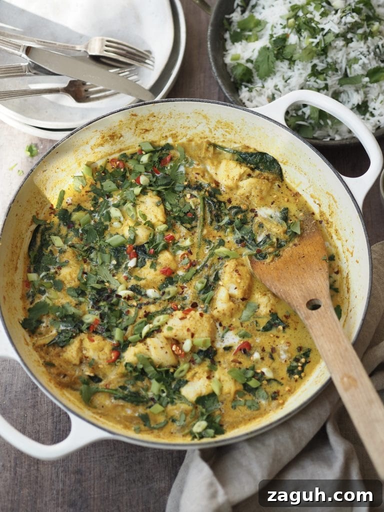 Quick Coconut Fish Curry with Lemongrass and Lime 7 A cod and coconut curry with wilted spinach and red chilli in a white casserole dish.